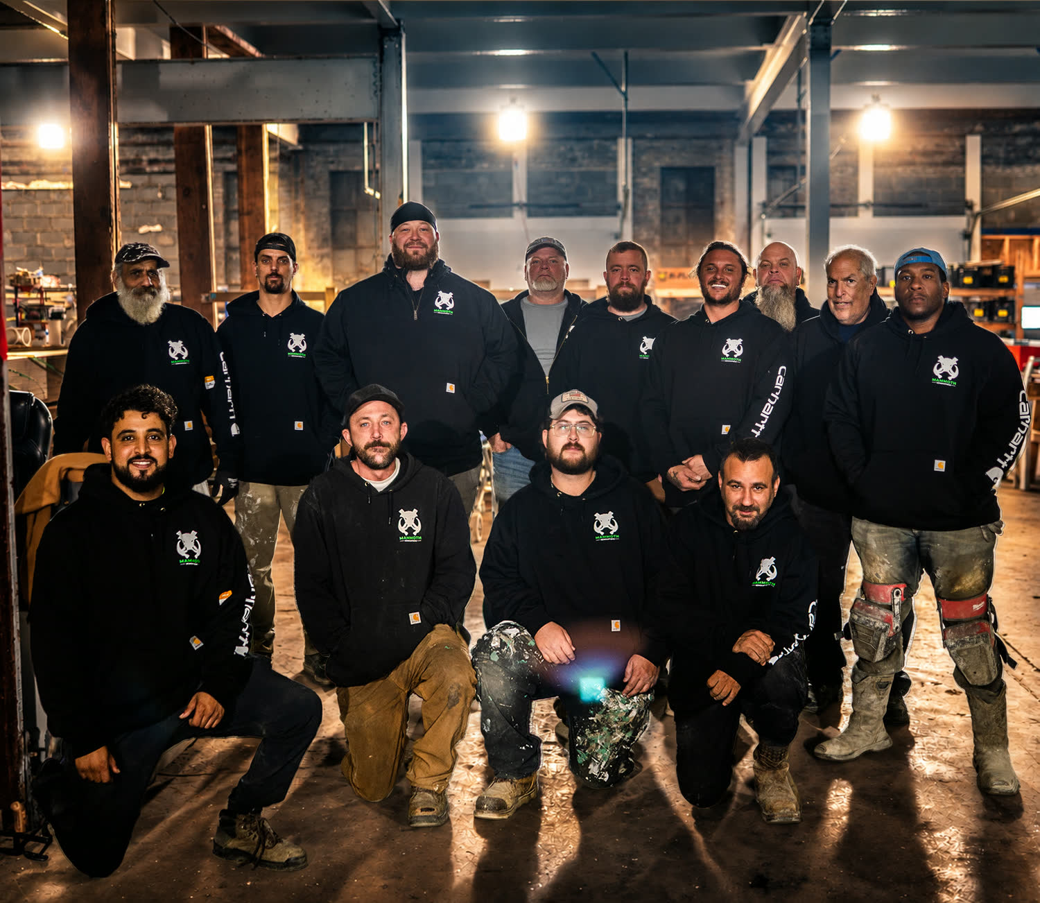 The Mammoth Renovations crew in their black hoodies inside the shop